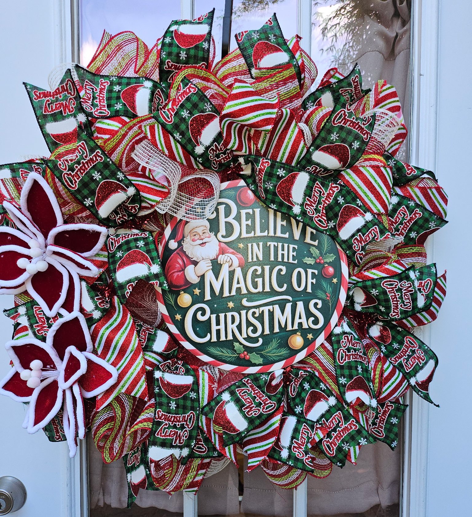 Christmas Wreath with Santa Claus Sign and Red and Green Ribbon Bows